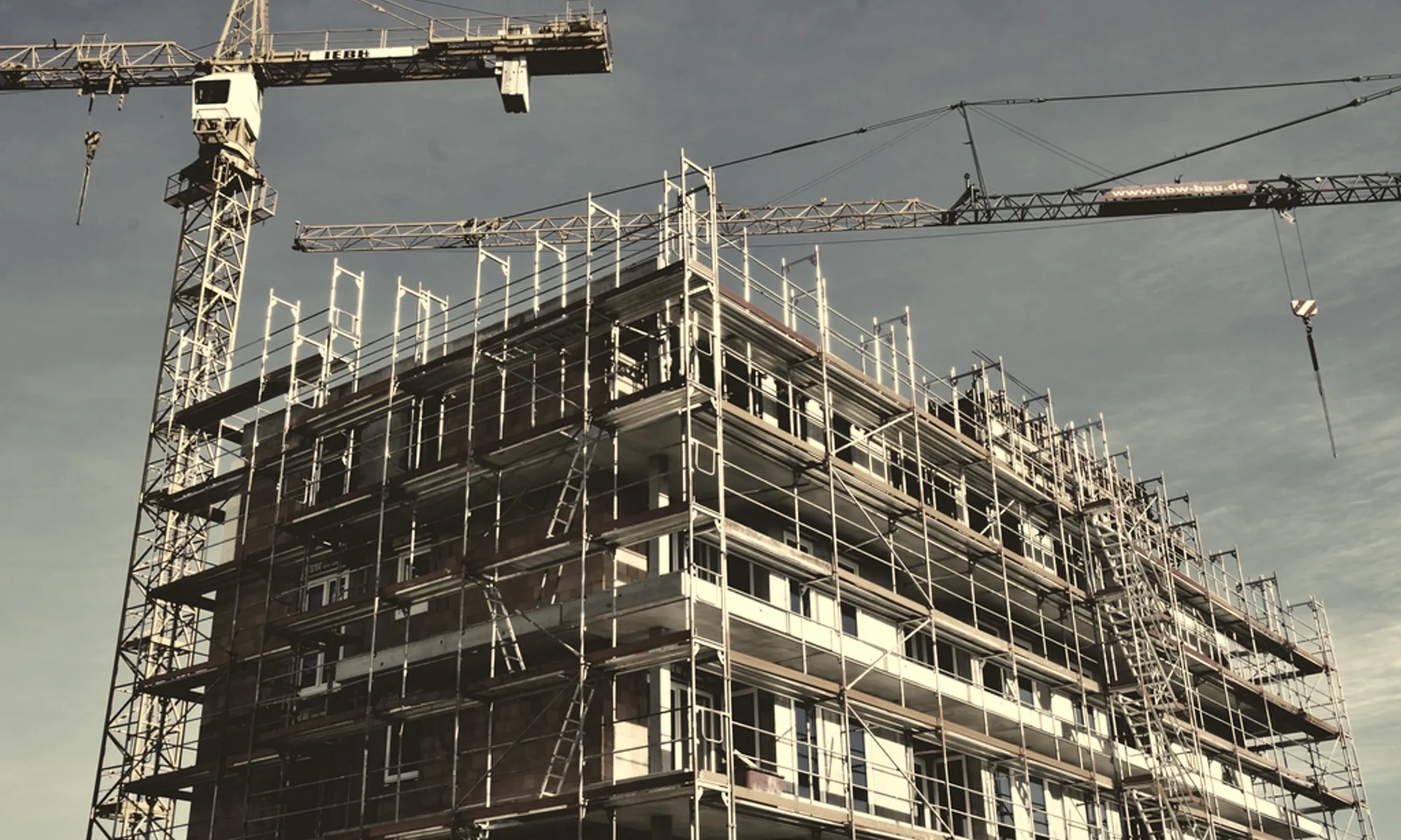 Cranes working above a steel and concrete frame